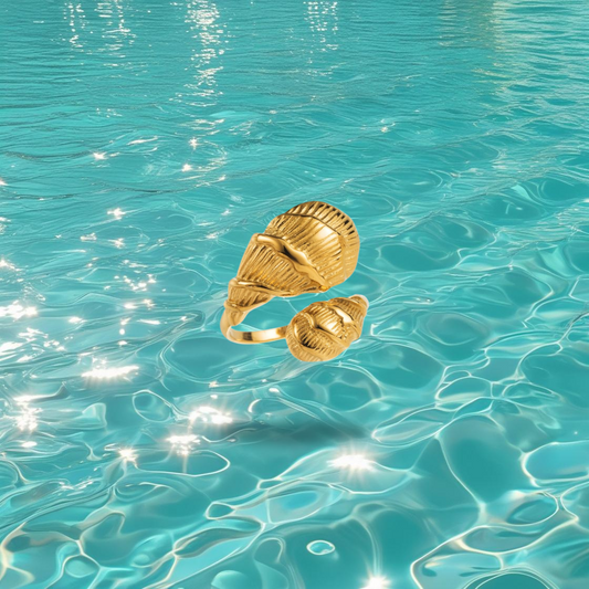 Bague Rocha dorée réglable avec double coquillage, bijou marin sur fond d’océan.